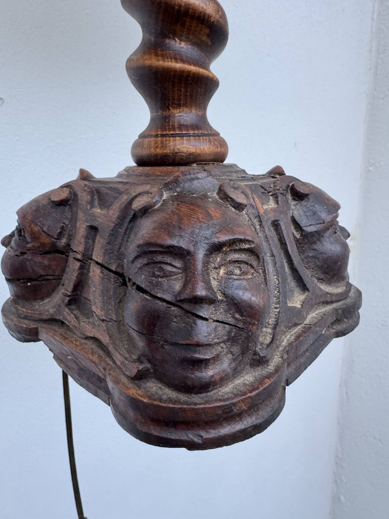 Sculpted wooden lamp with faces, antique.