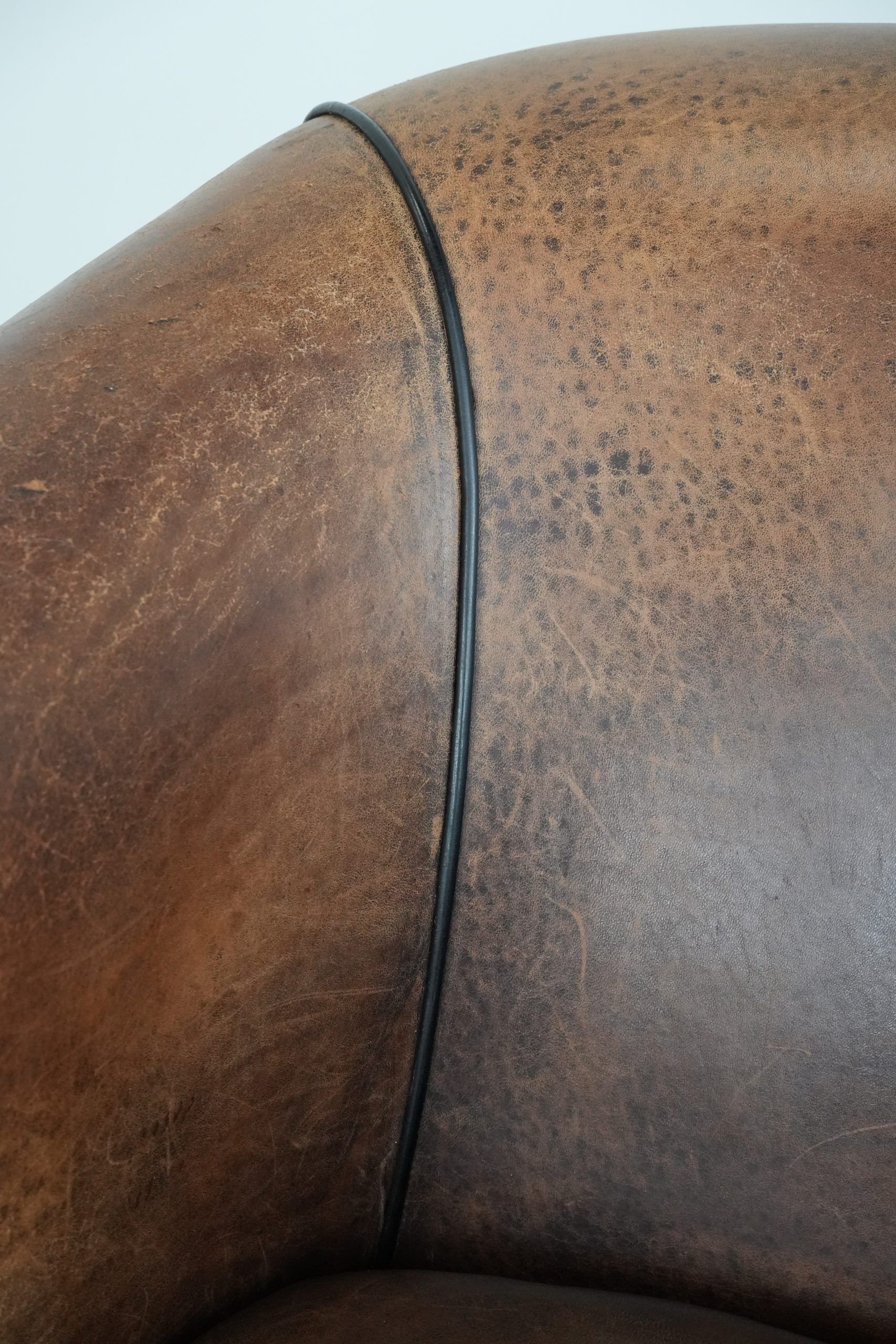 Sturdy vintage sheepskin club armchair with a beautiful patina