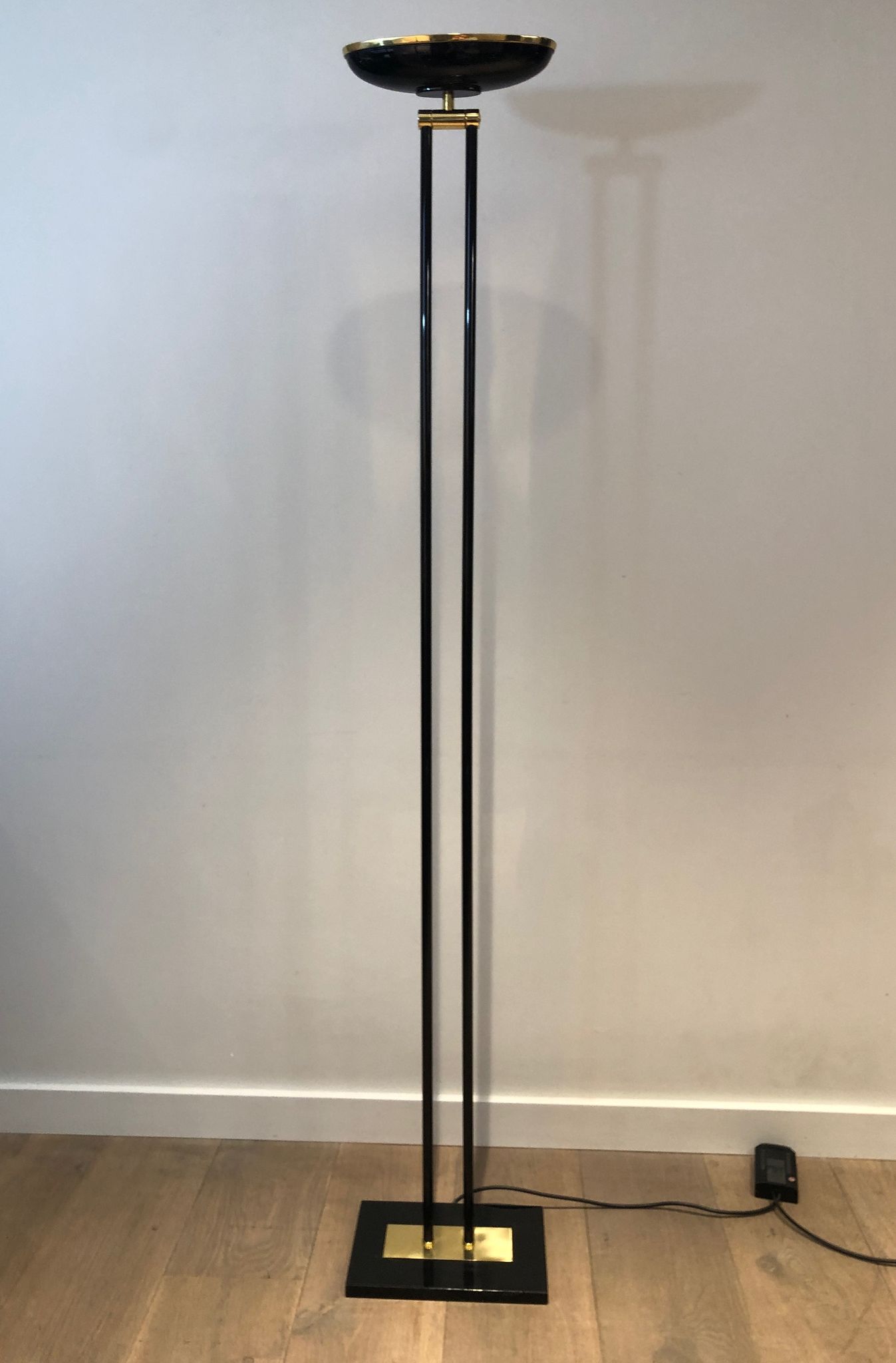 Black lacquered metal floor lamp with brass.