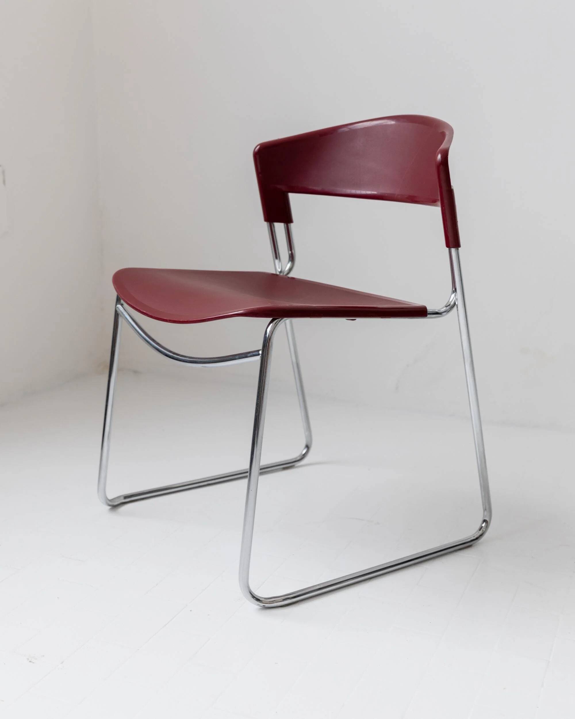 Vintage dining chair from the 1980s by Paolo Favaretto for Assisa, stackable, design Italy 1986 - chrome and red plastic - a classic of design.