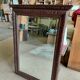 Large bevelled mirror with a carved wooden frame