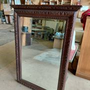 Large bevelled mirror with a carved wooden frame