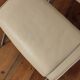 Beige leather armchair and footstool