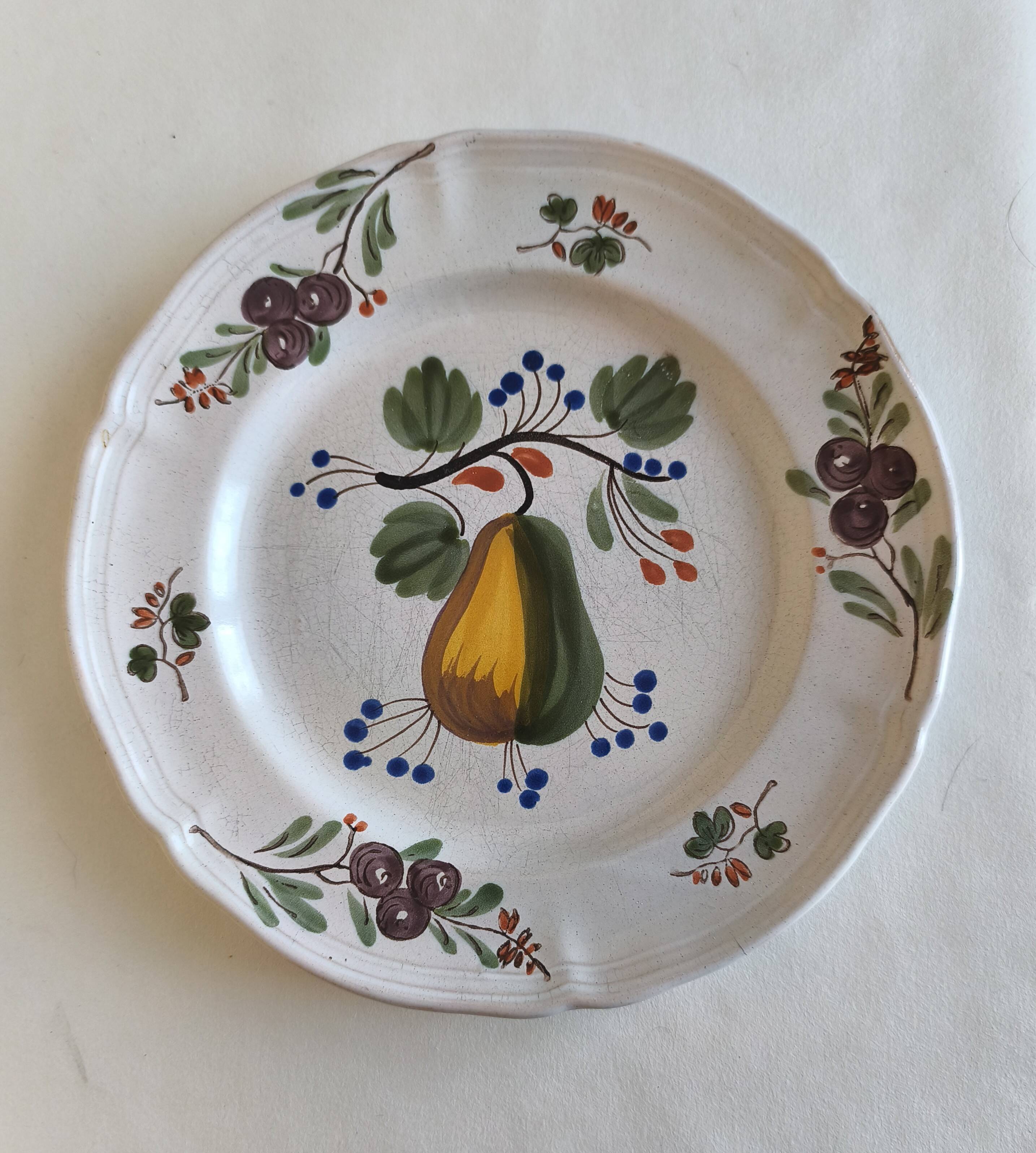 Two earthenware plates with fruits, pears and plums.