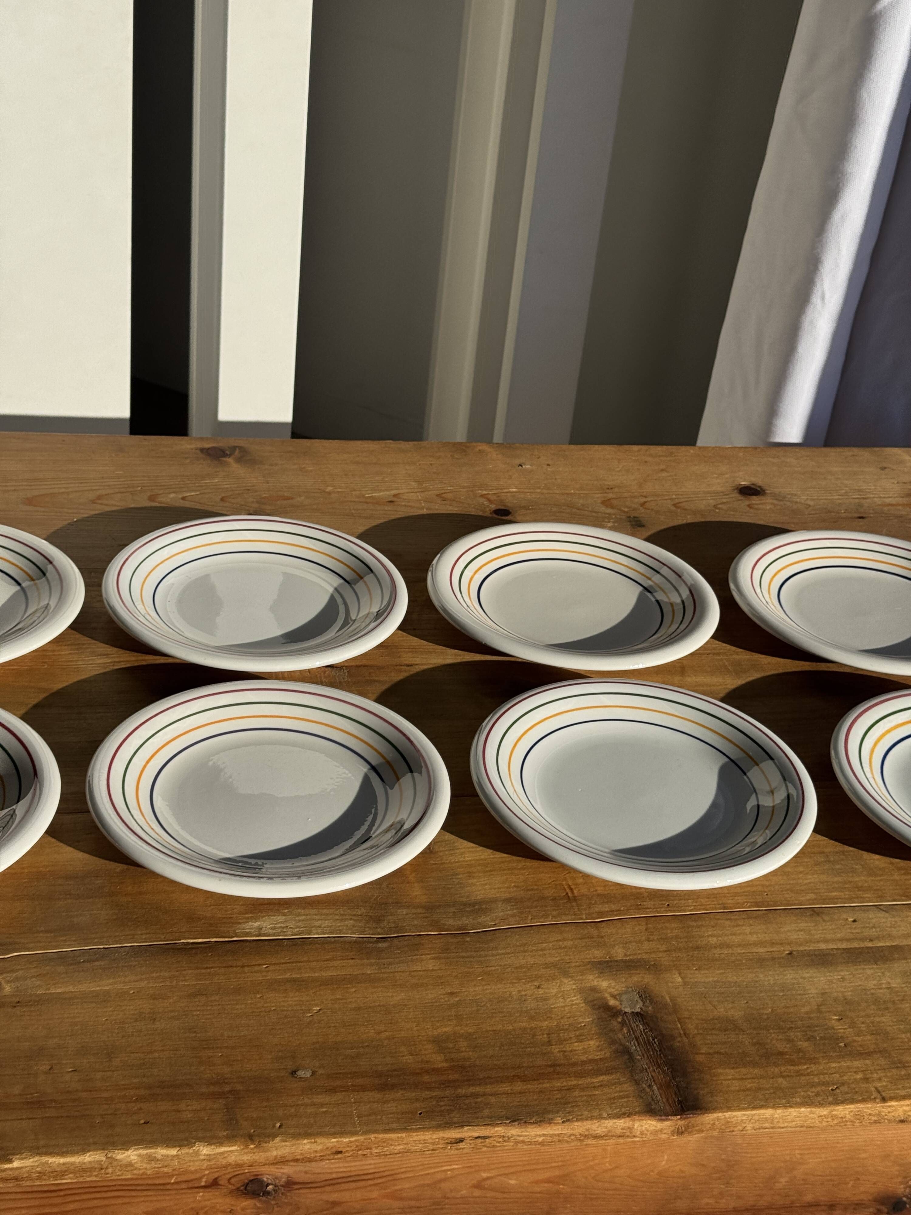 Set of 9 small Italian dessert plates Primula with red and green trim.