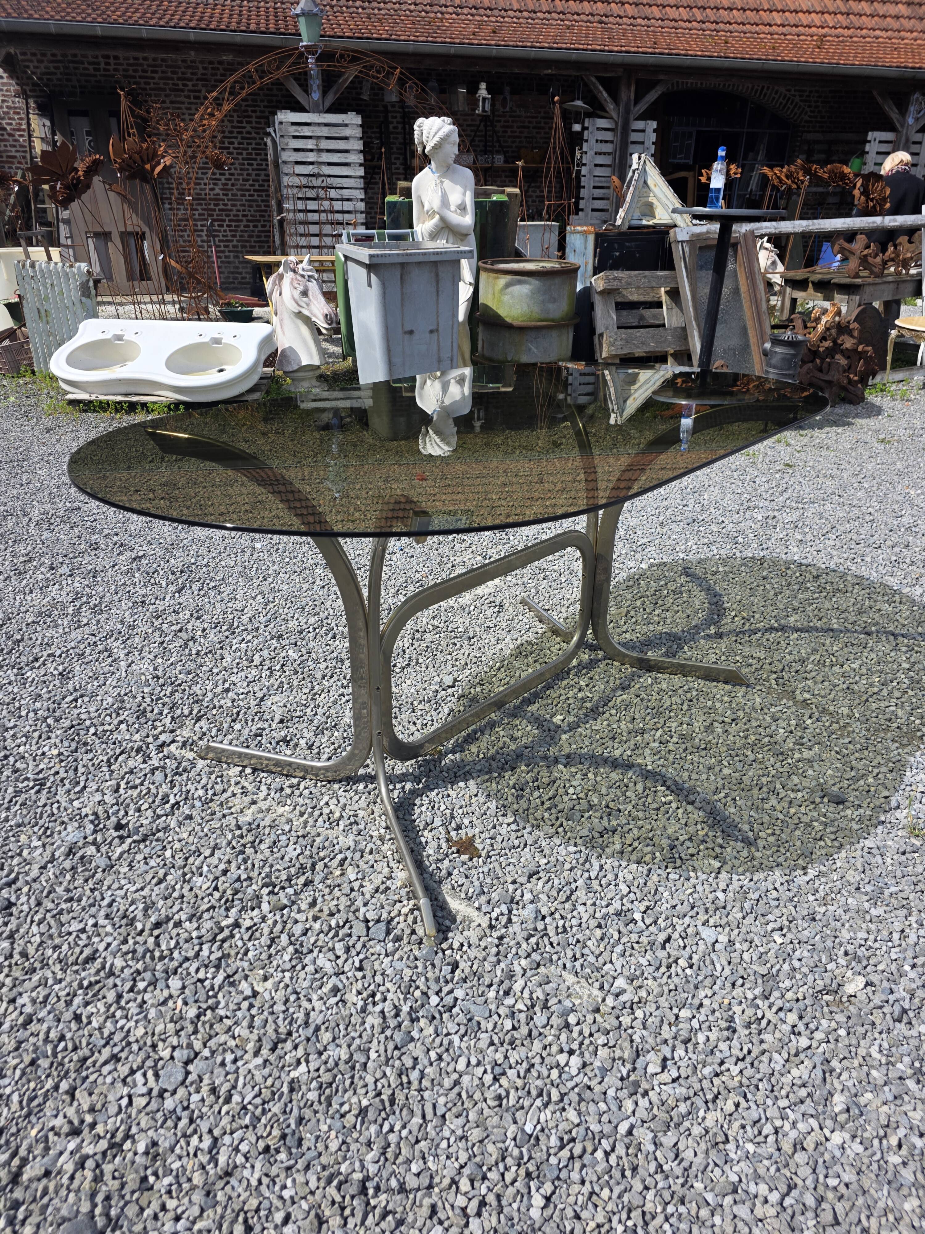 Silver metal table with smoked glass top from the 1970s.
