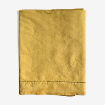 Old linen and cotton sheet tinted in curry yellow