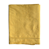 Old linen and cotton sheet tinted in curry yellow