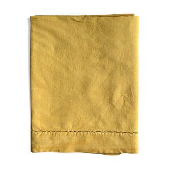 Old linen and cotton sheet tinted in curry yellow