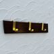 Vintage wooden and brass coat rack with 3 hooks from the 1960s.