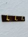Vintage wooden and brass coat rack with 3 hooks from the 1960s.