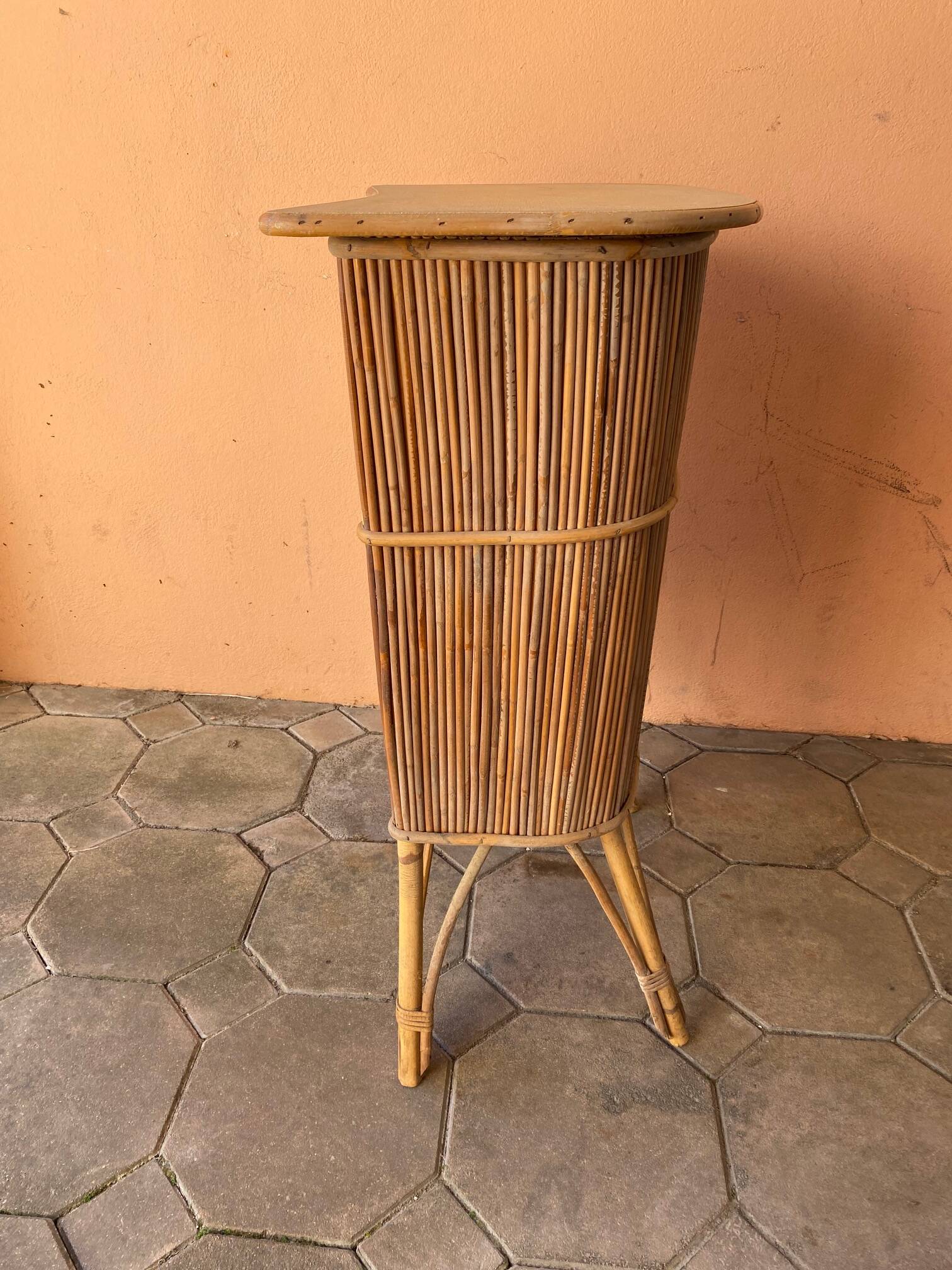 Vintage rattan bar from the 60s with rounded shapes and a shelf for glasses