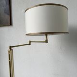 Floor lamp with articulated arm in brass-plated metal