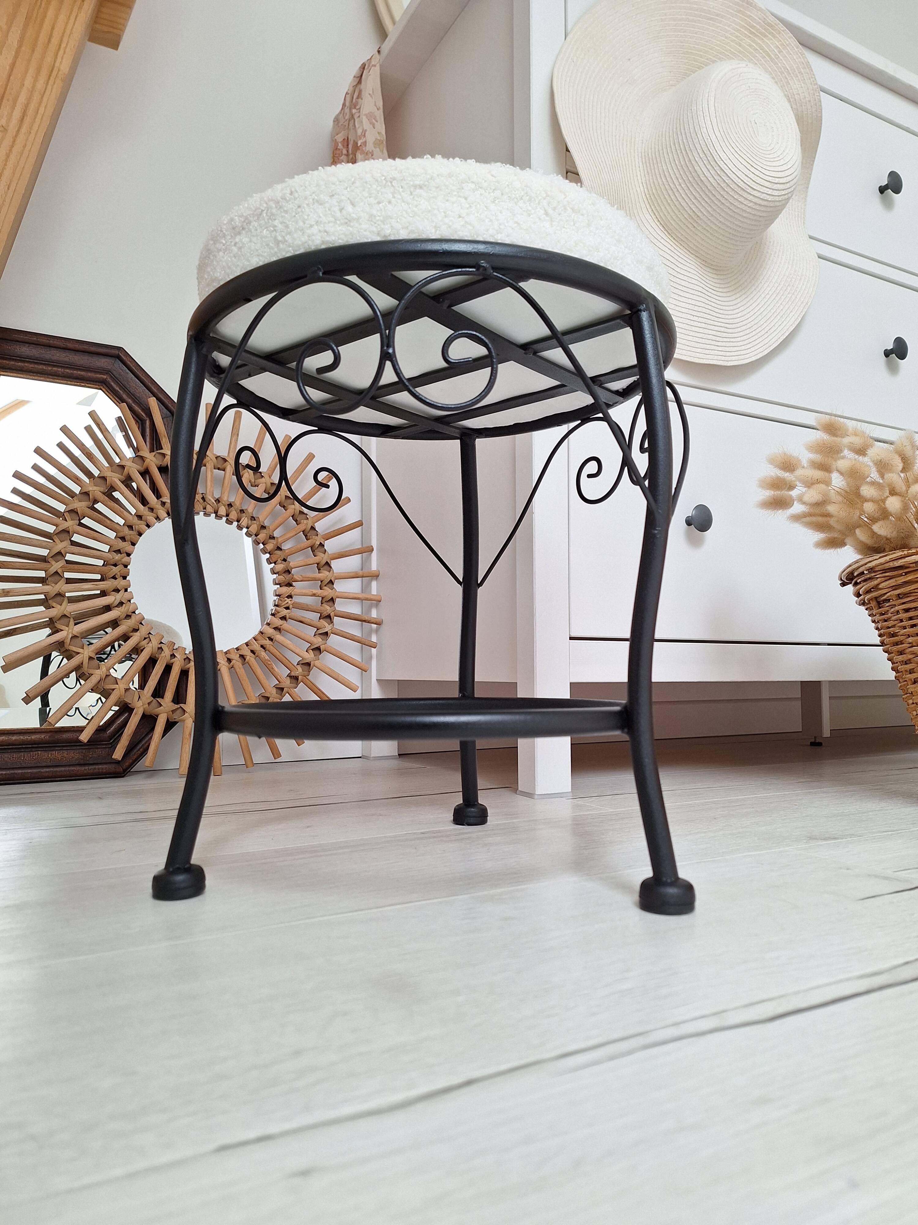 Black iron stool/pouf with its boucle fabric cushion.