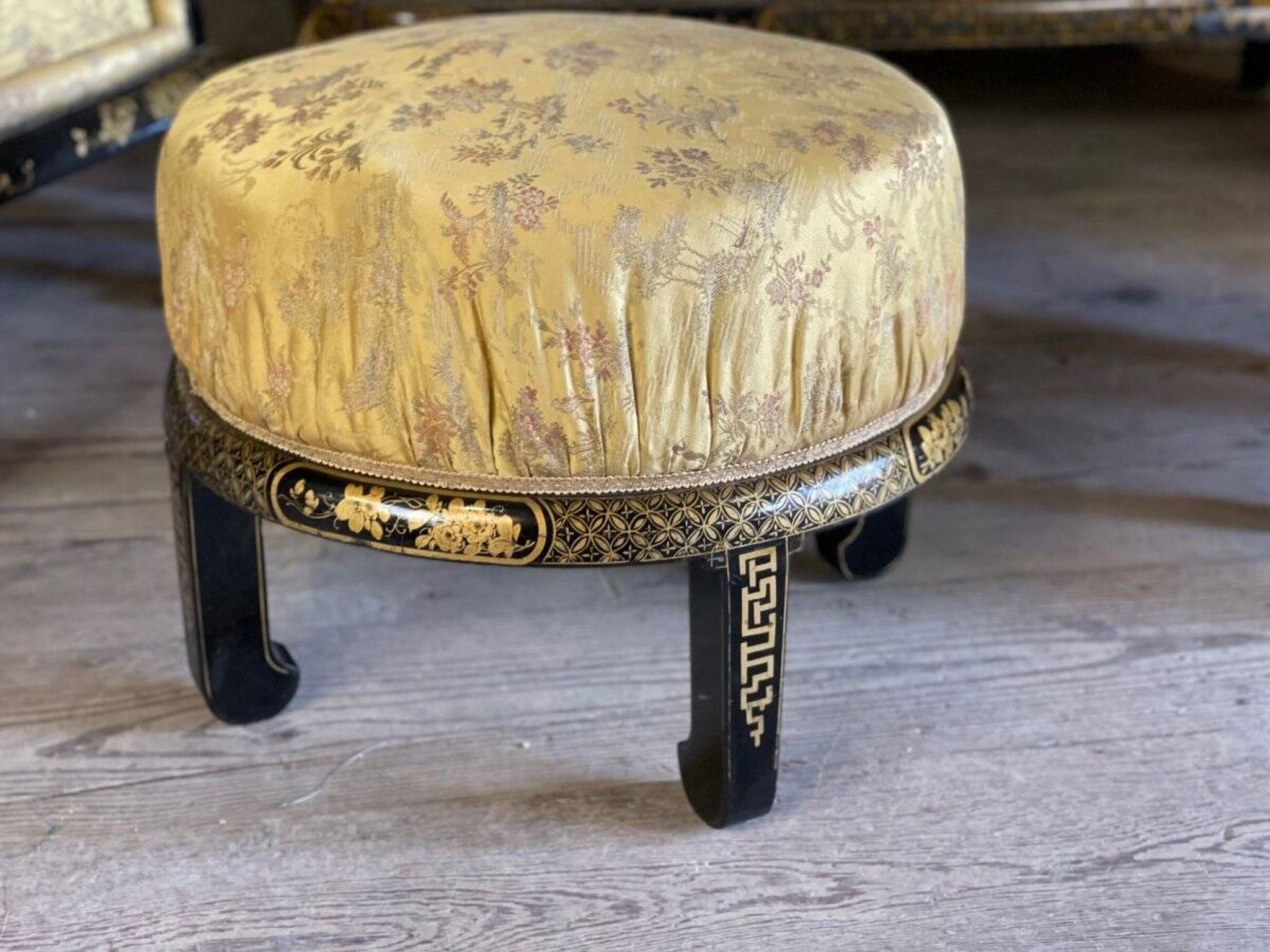 A set of two armchairs, a sofa and two poufs in lacquered wood with gilded chinoiserie decoration.