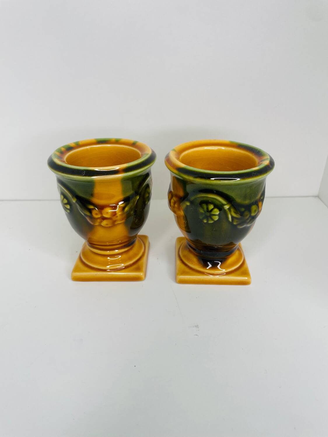 Pair of ocher and green ceramic point-a-line candlesticks