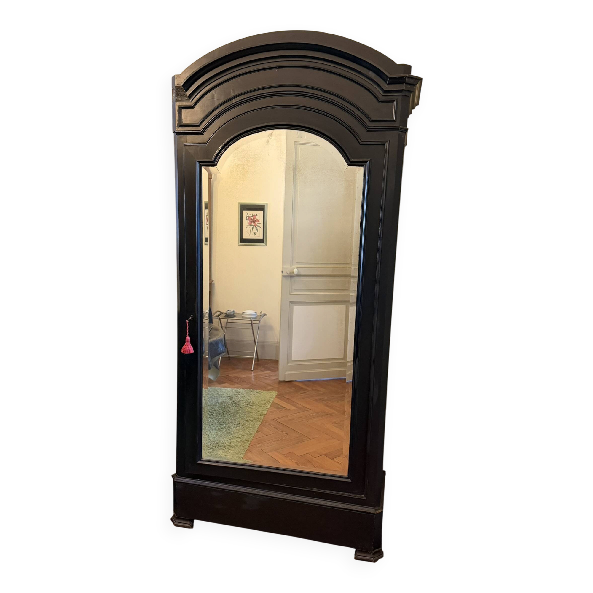 Black wardrobe with a mirrored door in ebony finish.