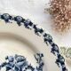 10 mismatched vintage soup plates in blue, green, and red ironstone