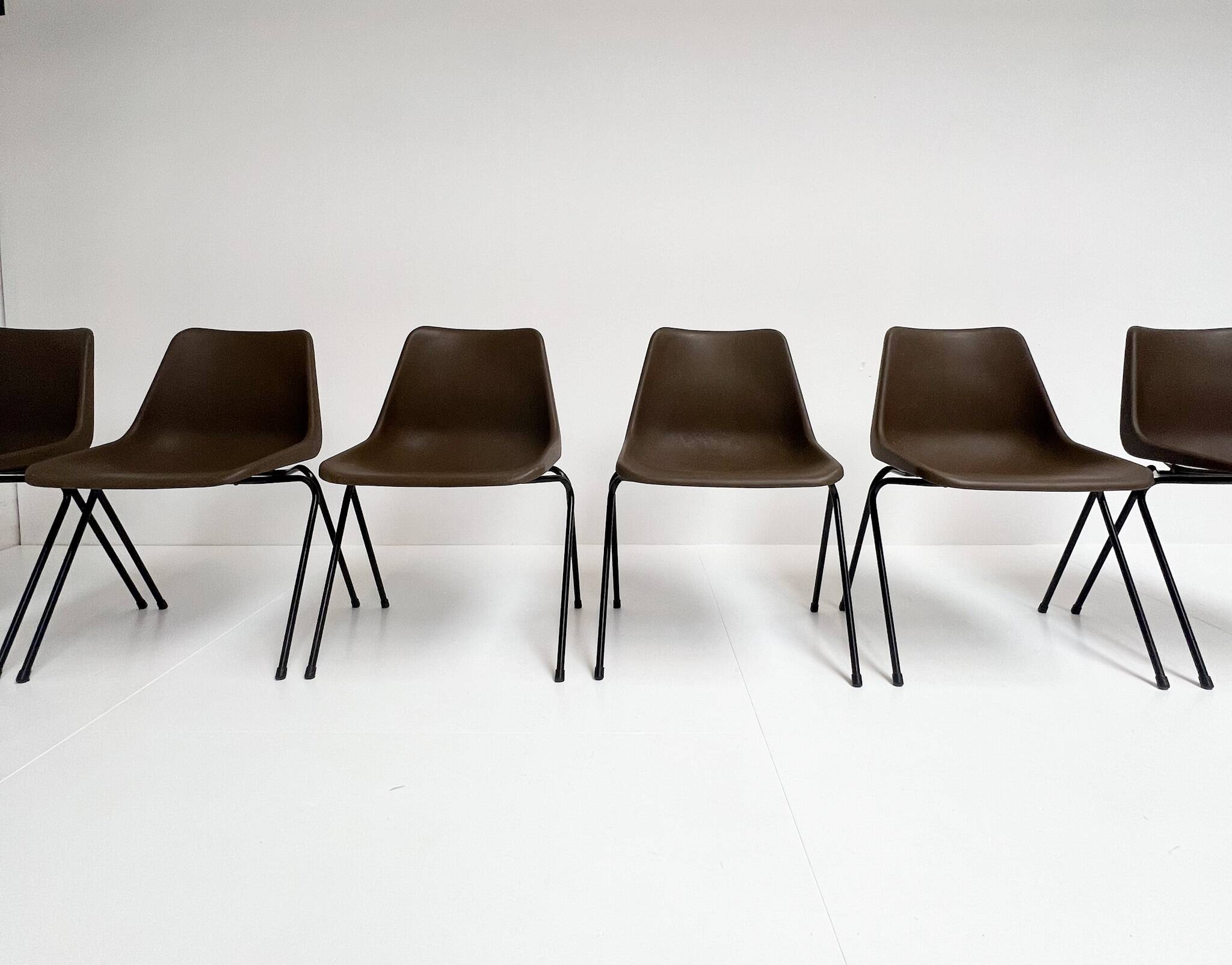 Brown and black set of 6 Polyprop chairs on a metal frame. The Polyprop cha