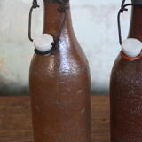 Set of 2 sandstone bottles with ceramic capsule