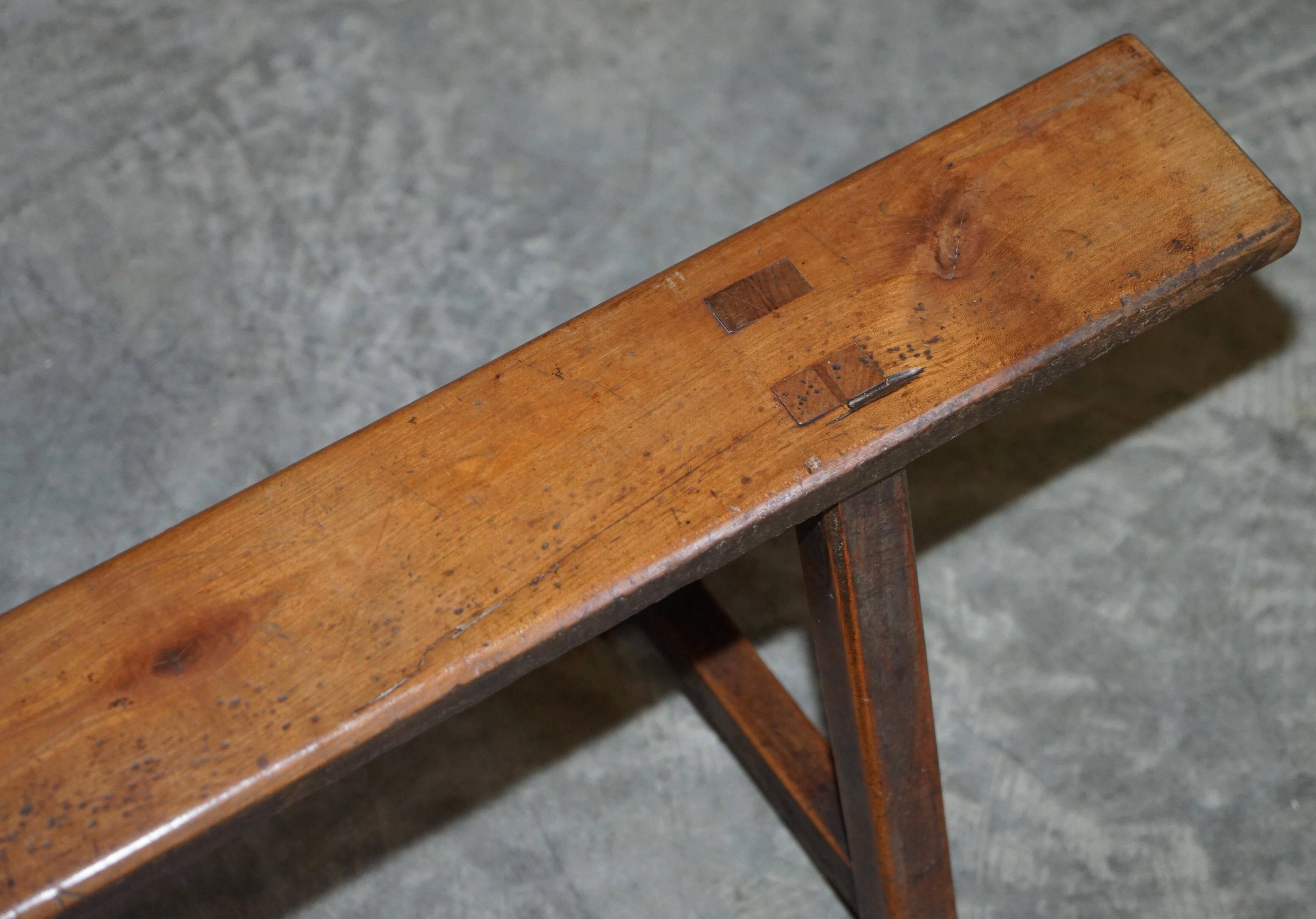 Pair of antique Victorian trestle benches in fruitwood.