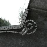 Beveled mirror with art-deco wrought iron frame and floral decor with hanging chain