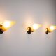 Set of three brass sconces with decorated yellow glass shades