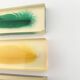 Six feather-shaped knife rests in resin inclusion.