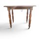 Antique drop-leaf table in wood, with turned legs and castors.