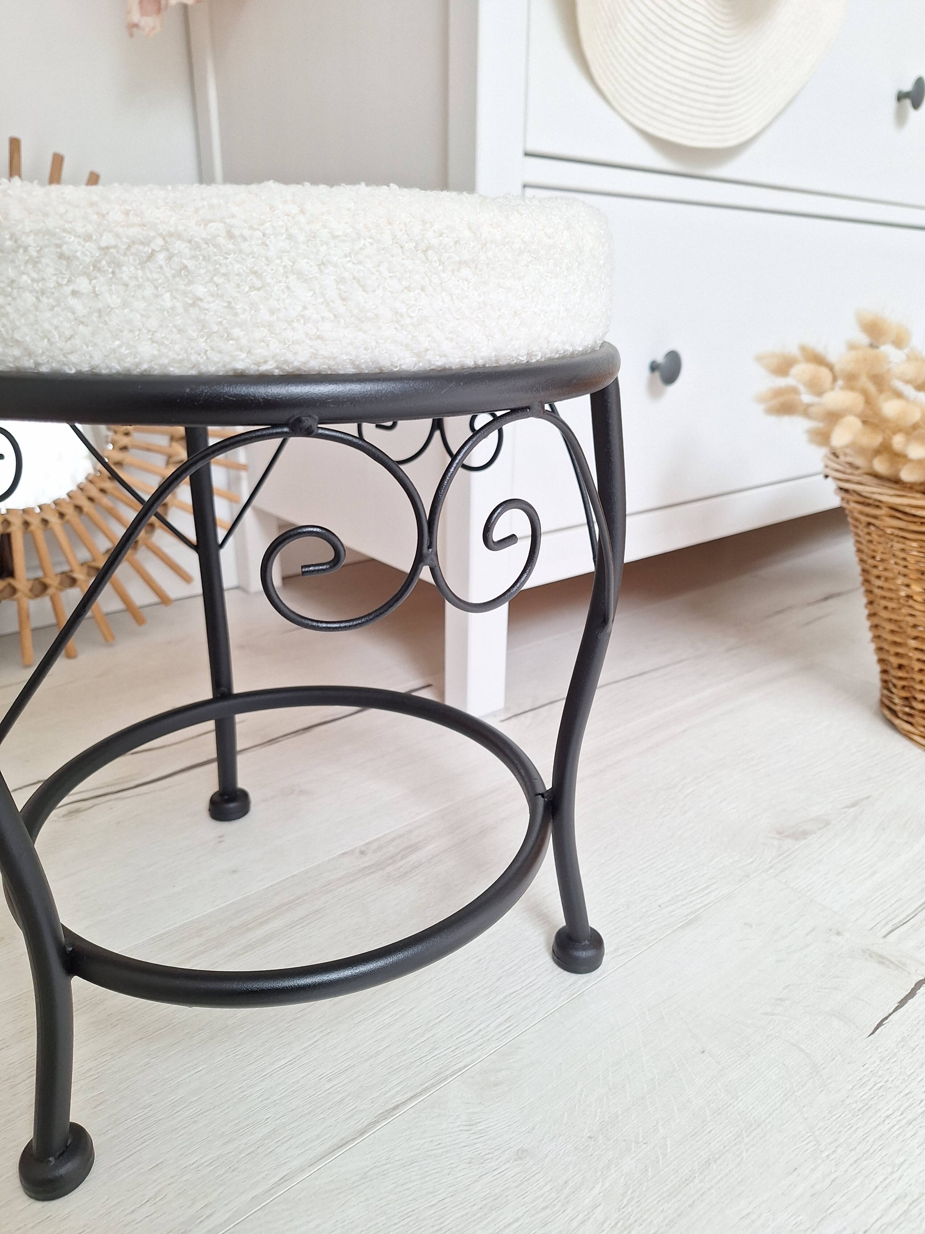 Black iron stool/pouf with its boucle fabric cushion.