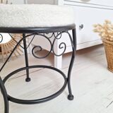 Black iron stool/pouf with its boucle fabric cushion.