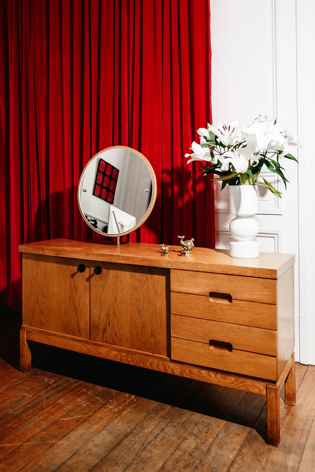 Vintage oak cabinet with circular mirror, 1960s modernist design.