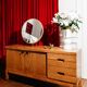 Vintage oak cabinet with circular mirror, 1960s modernist design.