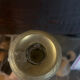 Large antique brass candlestick with floral decoration.