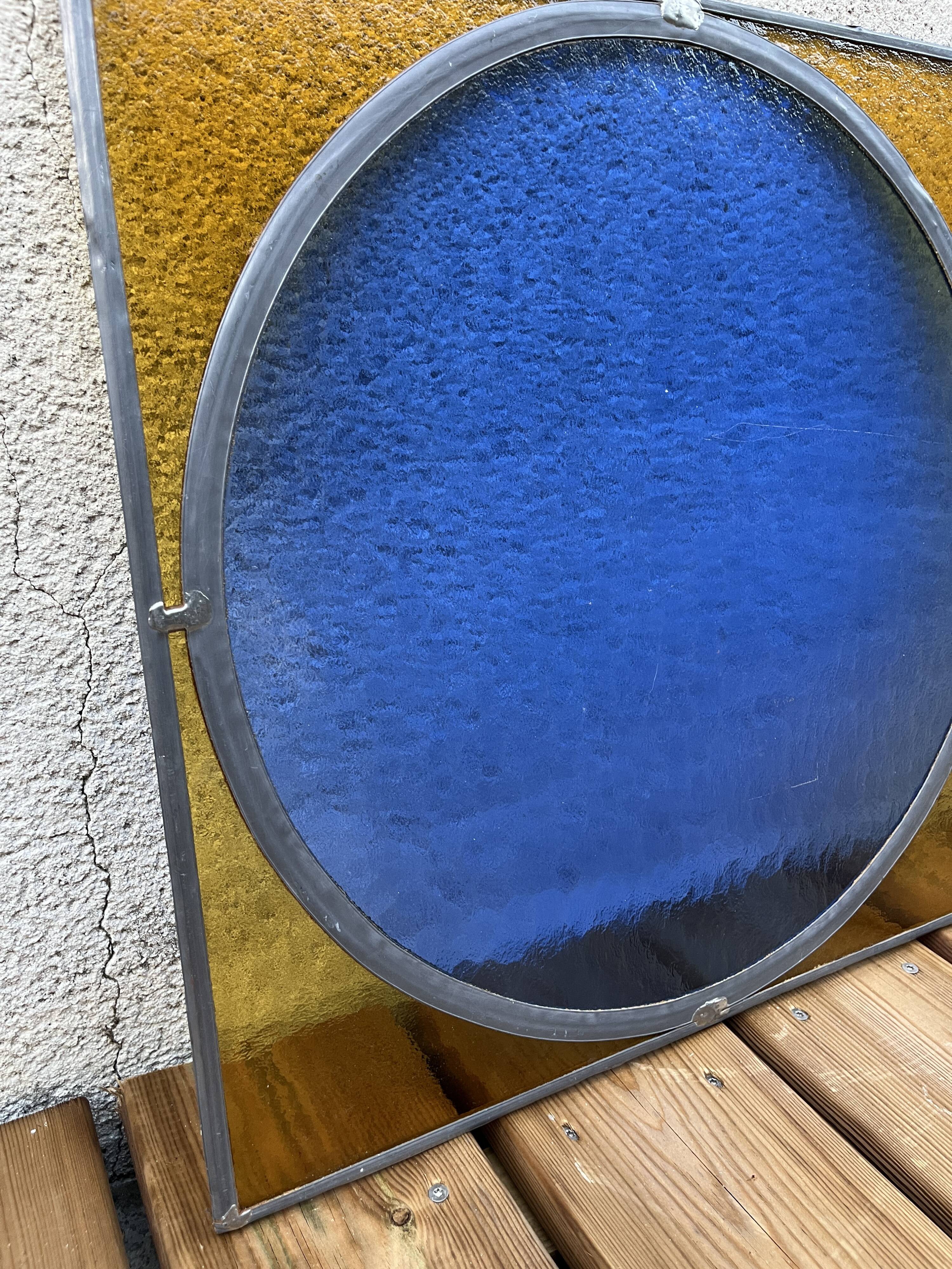 Pair of antique blue and yellow stained glass windows