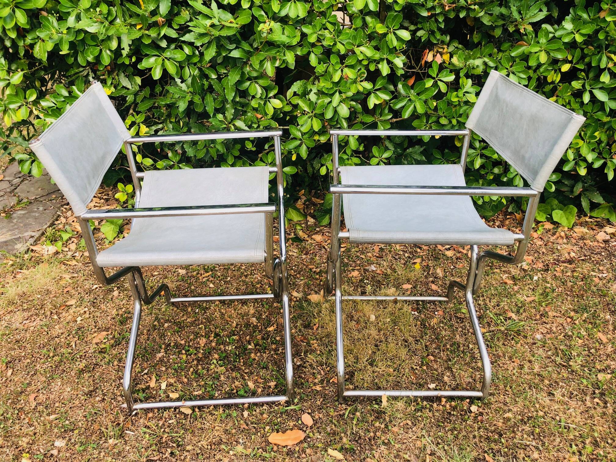 Pair of folding metal and leather armchairs