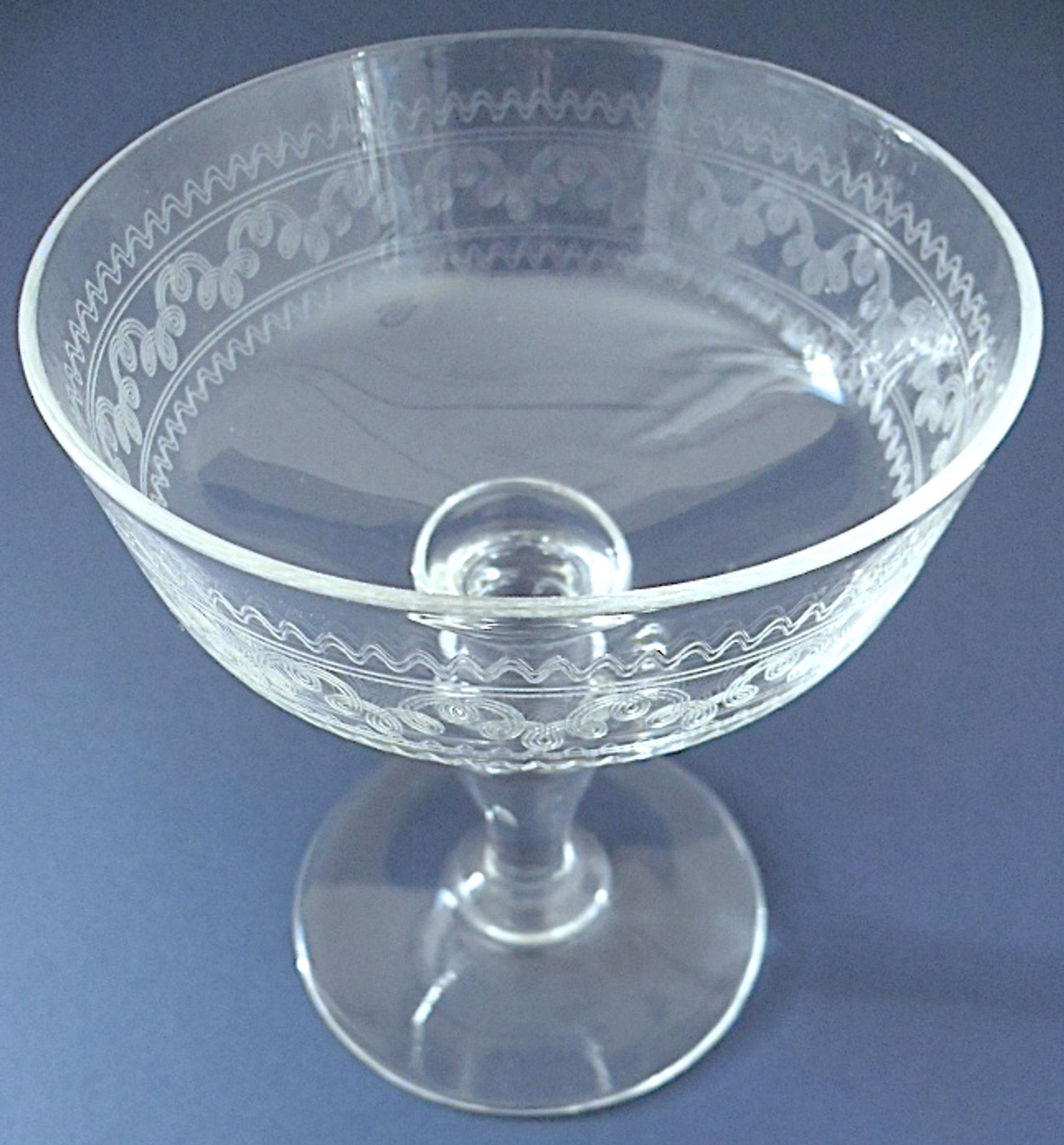 Suite of six champagne glasses on foot in engraved colorless crystal