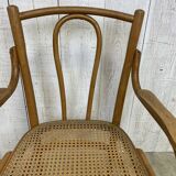 Curved wood and cane armchair