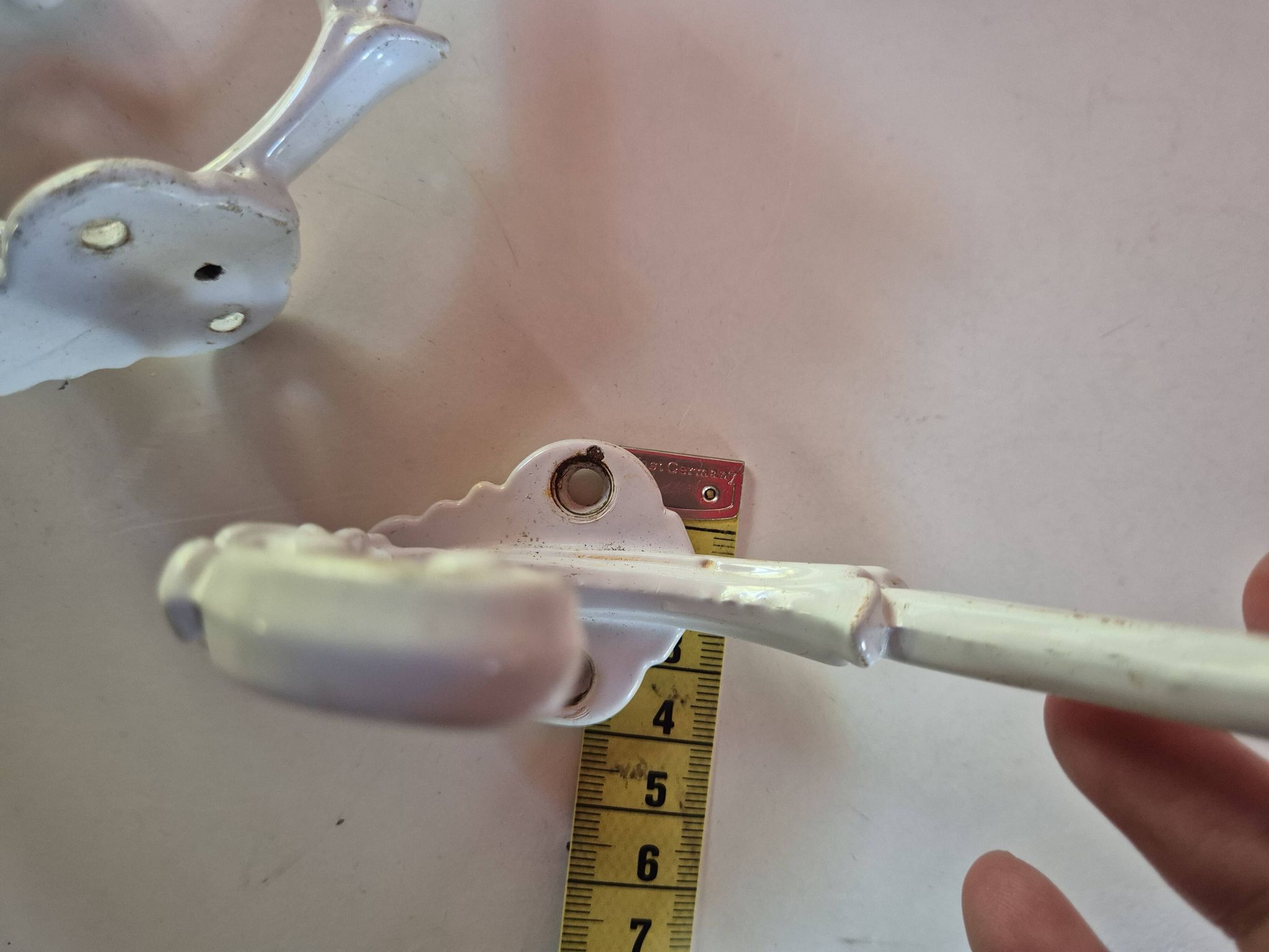set of 2 vintage white cast iron hooks, small paint chips from the year