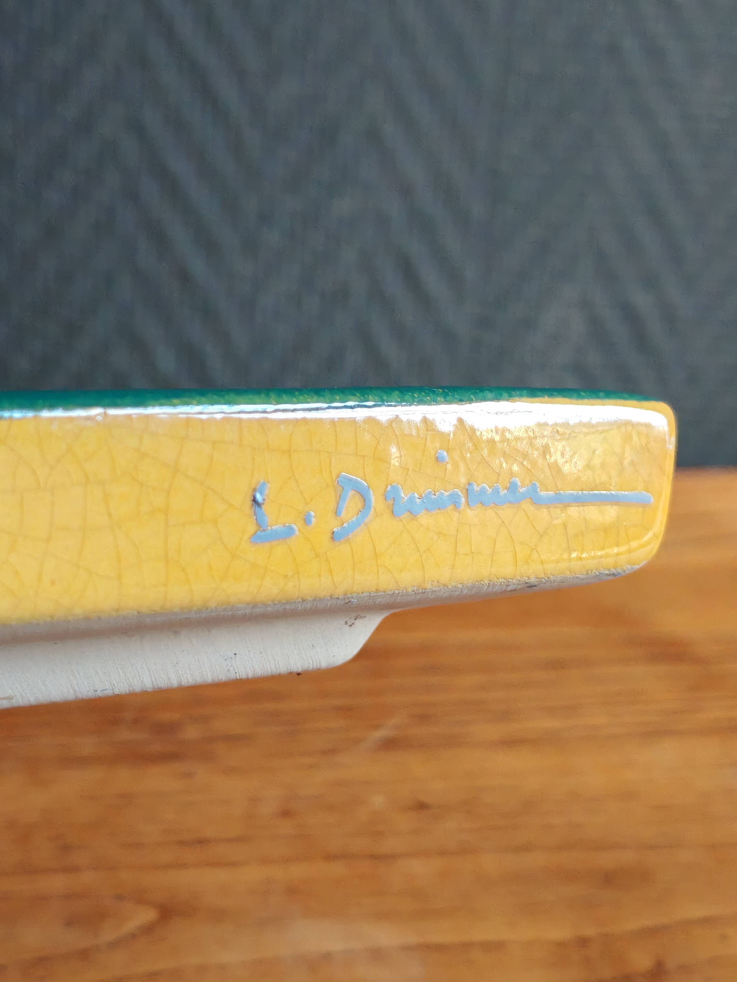 Yellow glazed ceramic trivet signed l. drimmer