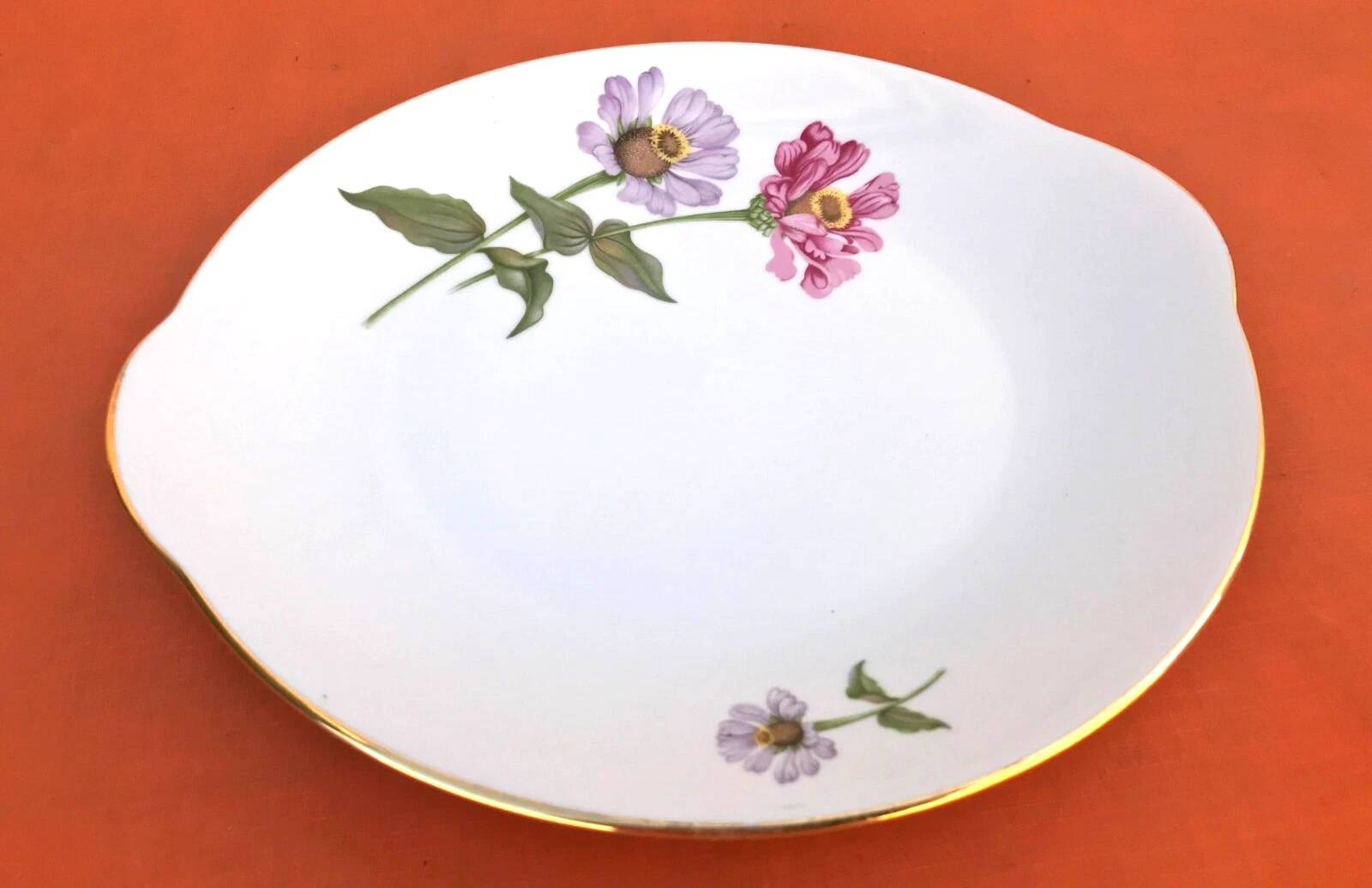 Serving dish with handles, fine Bohemian porcelain with floral decoration on a background.