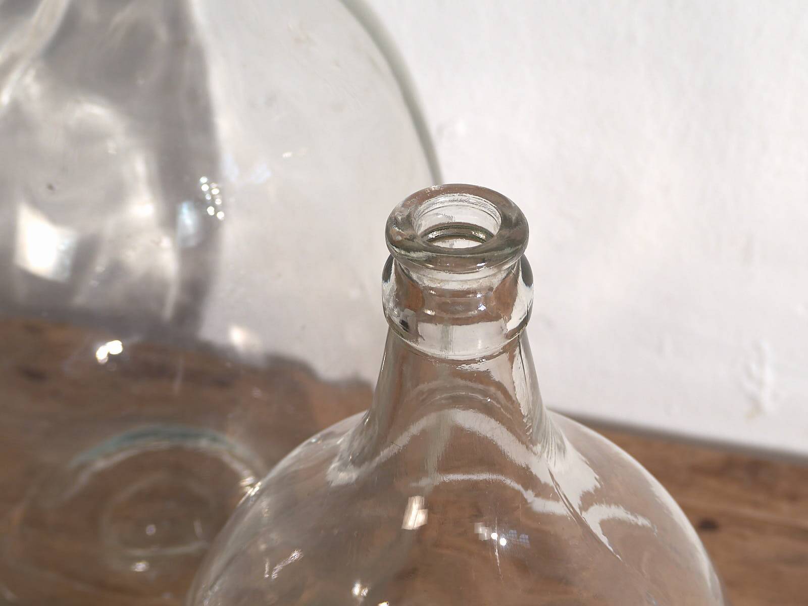 Antique glass demijohns (c.1920). Set of 2 pieces