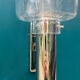 Wall lamp in stainless steel and globe in transparent glass