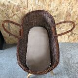 Old woven wicker baby cradle