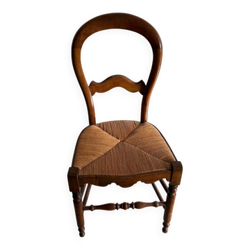 Antique wooden chair with woven straw seat – rustic style