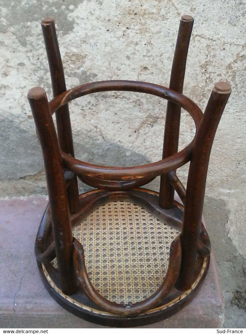 Low stool with canned seat and curved wood