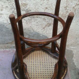 Low stool with canned seat and curved wood