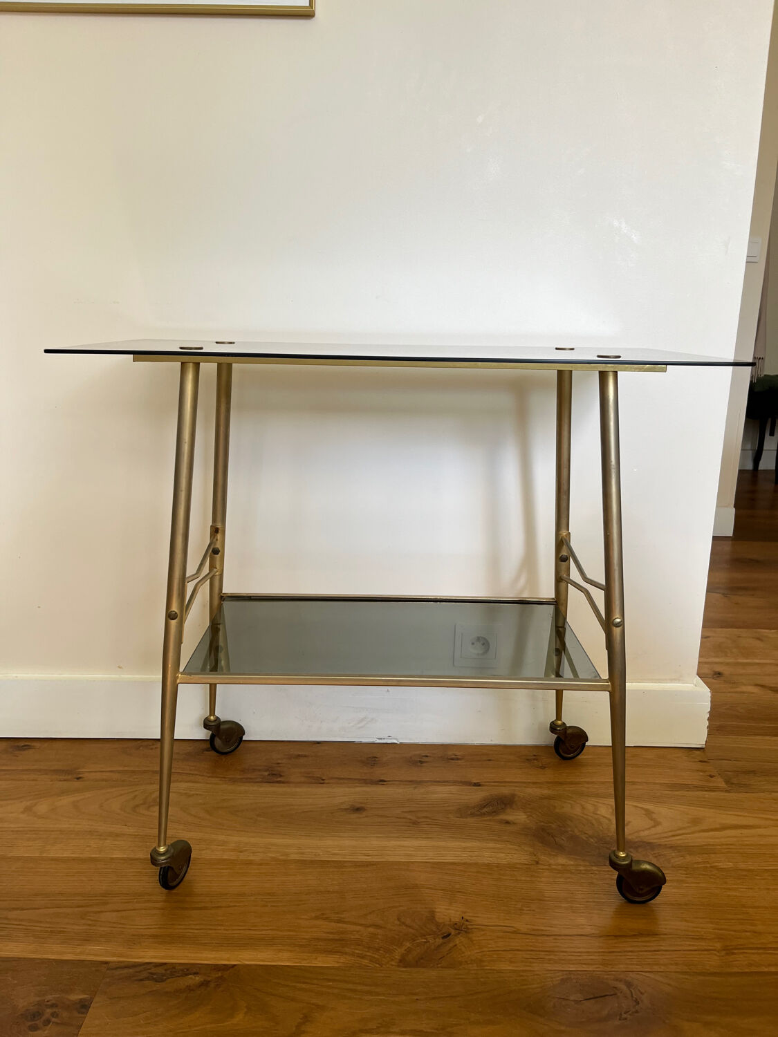 Vintage brass and smoked glass dessert trolley on wheels.