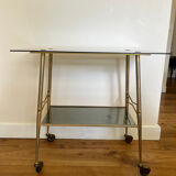 Vintage brass and smoked glass dessert trolley on wheels.