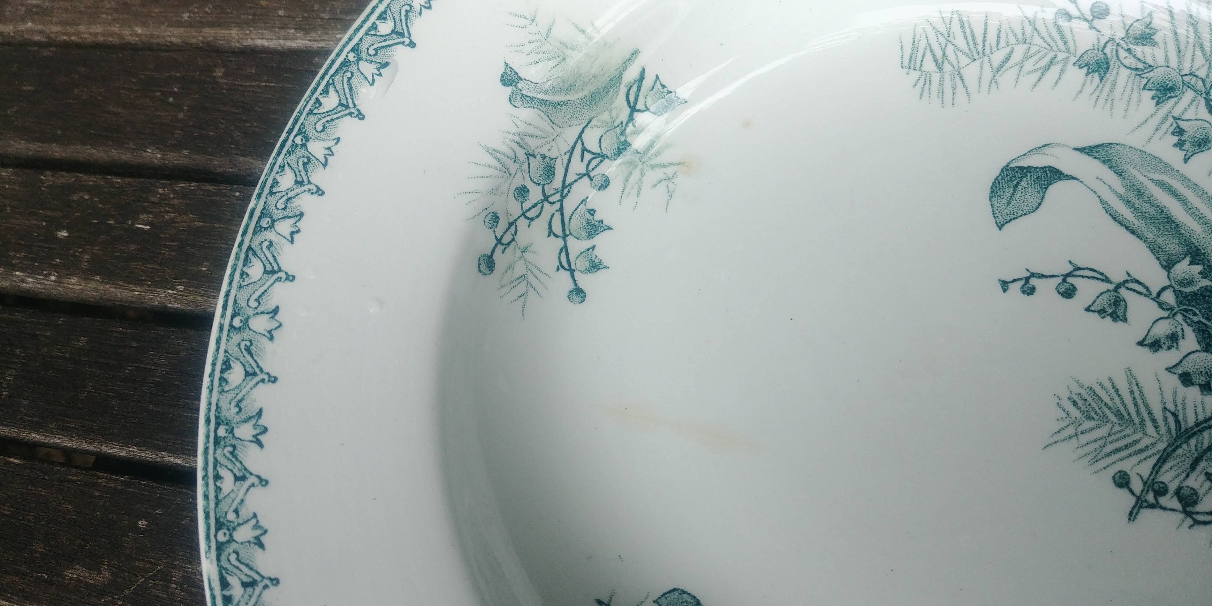 Set of three iron earthenware plates from the St Amandinoise earthenware factory, lily of the valley model.